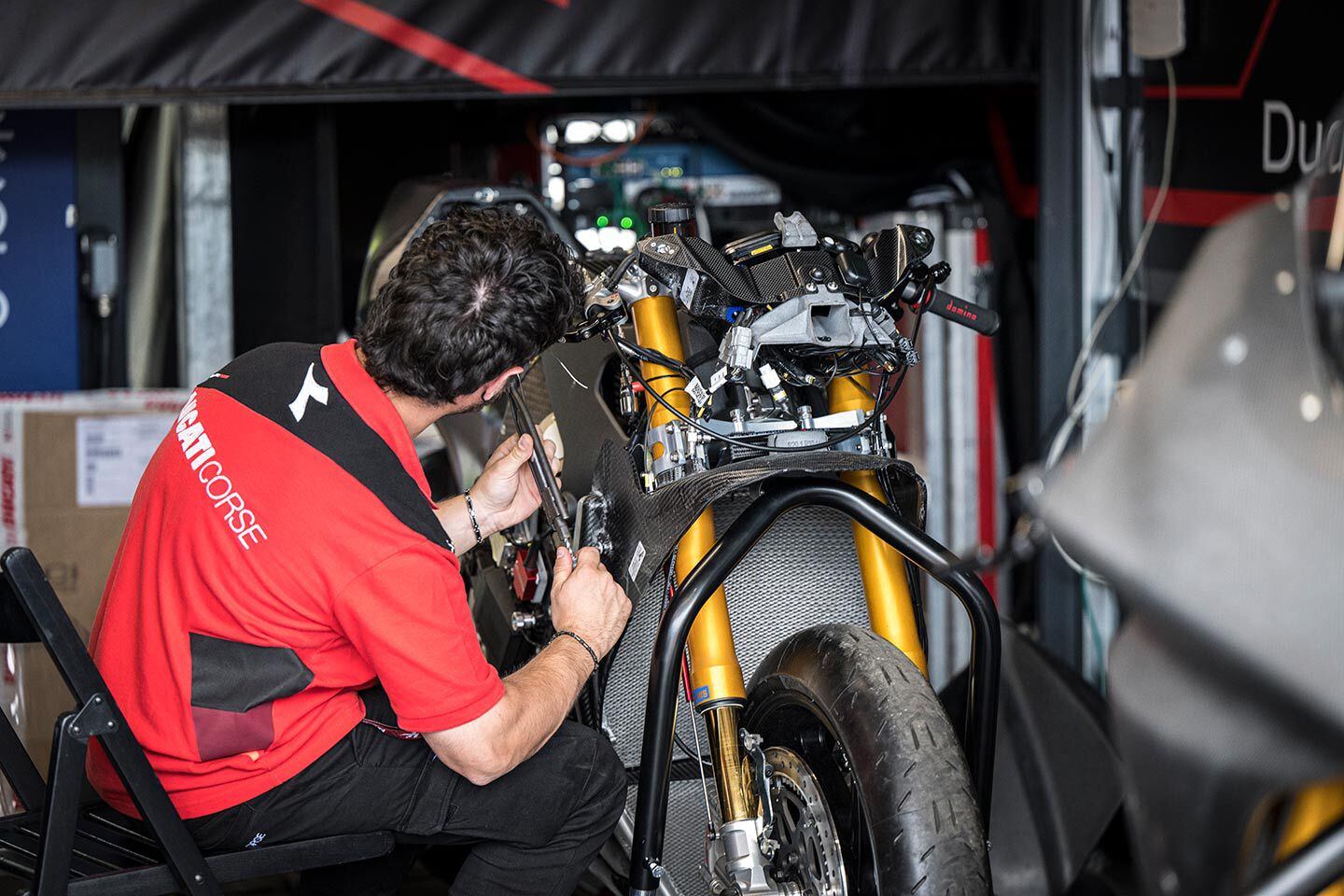 A Ducati tech prepares a spare bike ahead of race 1 at Mugello.