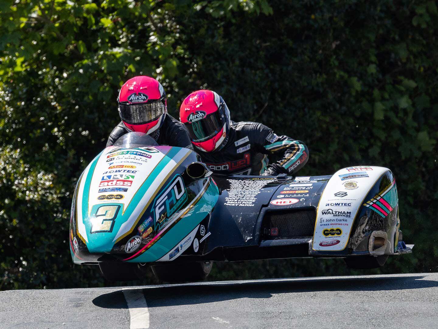 Taking flight at Ballaugh Bridge and close behind the Brichalls was the FHO Racing Team of Peter Founds and Jevan Walmsley, also on their Honda-powered sidecar.