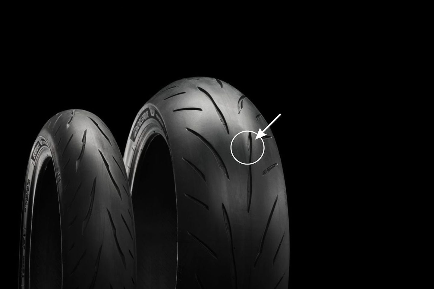 Wet-weather performance is improved thanks to the addition of Bridgestone’s Pulse Groove technology on the rear tire. The reshaped groove with center deflector (circled) accelerates water through the footprint better compared to a traditional groove.
