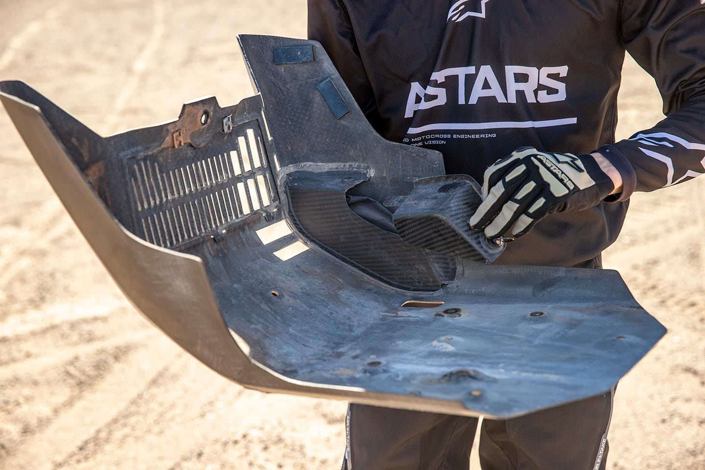A carbon fiber skid plate houses a small tool kit.