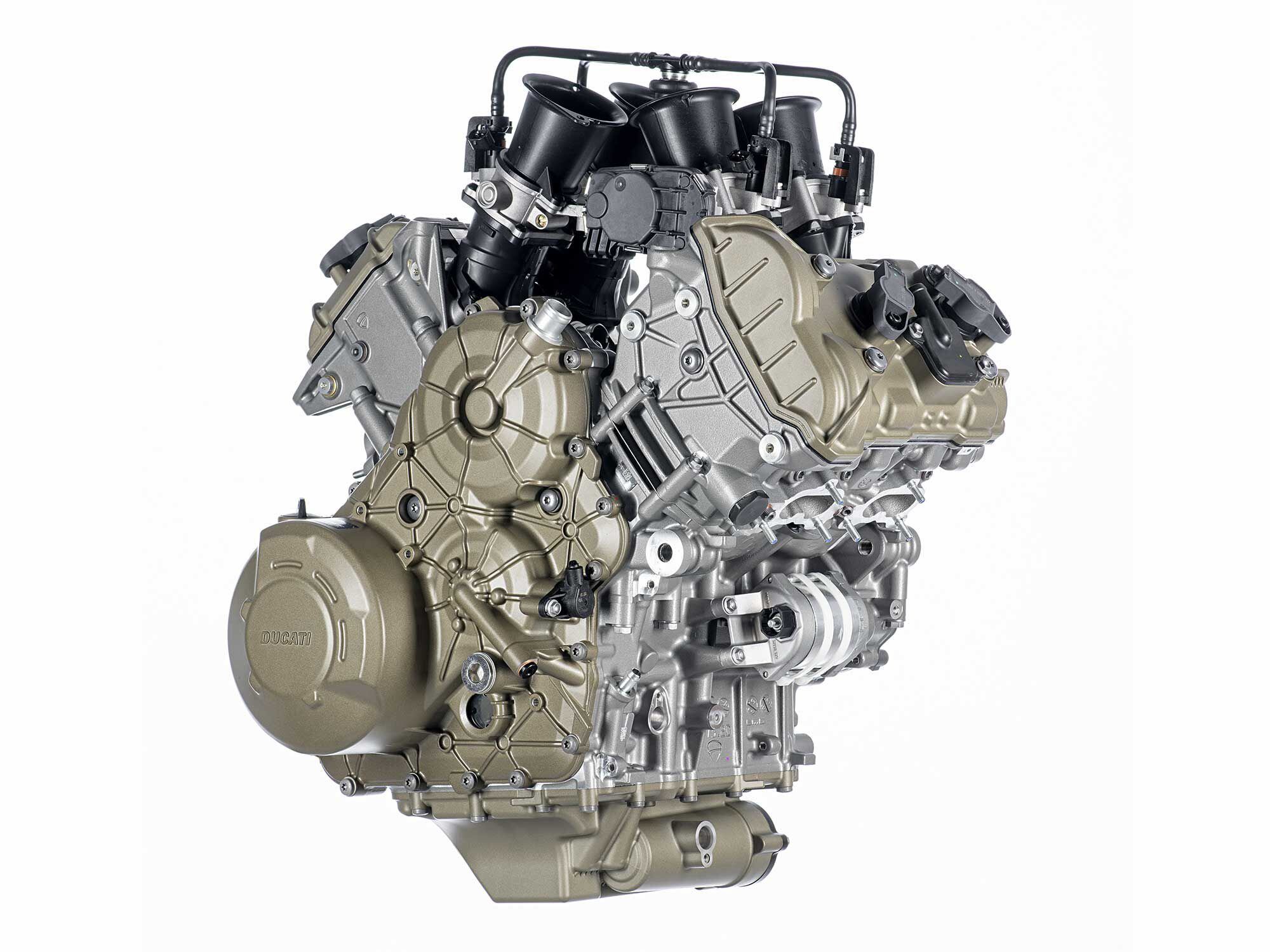 While the 1,158cc spring-valve Ducati V-4 Granturismo shares the same overall size and design of the Panigale V-4 desmo, it’s definitely shorter top to bottom, thanks to its more compact oil pan. Also note the arch in the intake runners. The V-4 Granturismo is fractionally heavier at 147.9 pounds versus 146.7 pounds for the Panigale. The V-4 Granturismo generates 170 hp at 10,500 rpm. That sounds like a big difference, but the two units generate about the same torque: 93.7 pound-feet for the Granturismo and 92.9 pound-feet for the Panigale V-4.