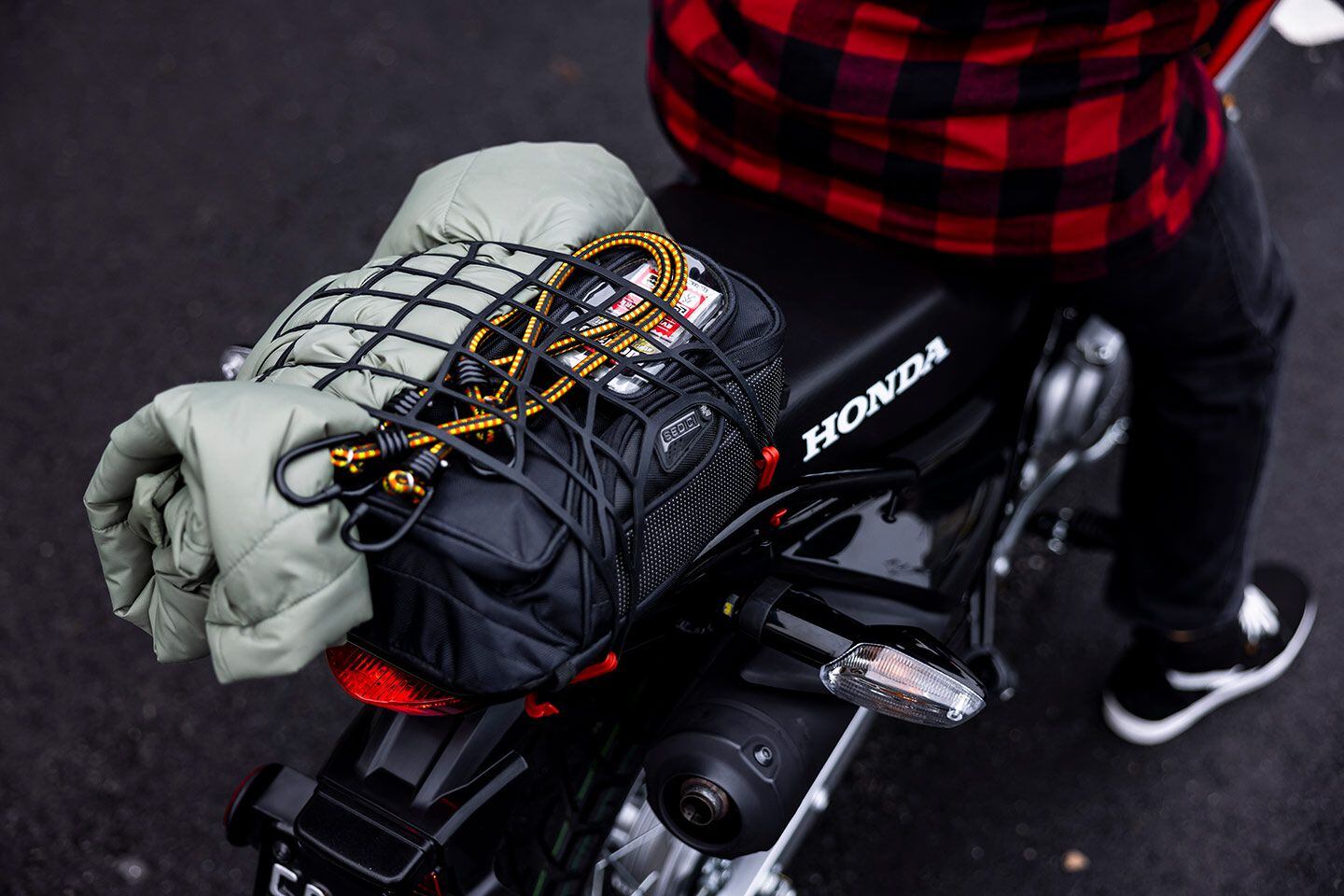 Between the standard rear rack and Honda’s accessory throw-over saddlebags, the XR150L is ready for adventure.