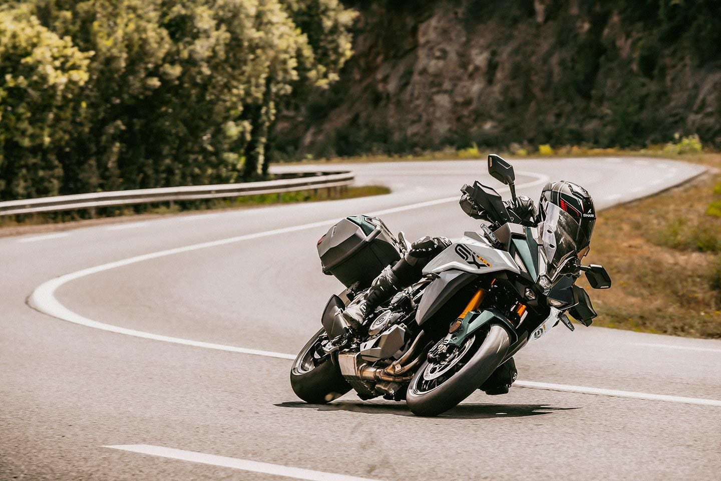 While other markets will get GX and GX+ in varying colors, Suzuki Motor USA will only import GX+ models in the Pearl Matte Shadow Green shown here. Notice the aggressive gear and lean angle, which is Suzuki highlighting the GX+’s sporty performance.