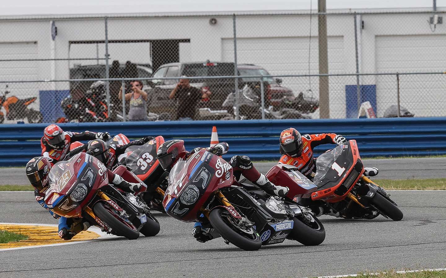 Troy Herfoss leads teammate Tyler O’Hara ahead of a three-pack of Harleys.