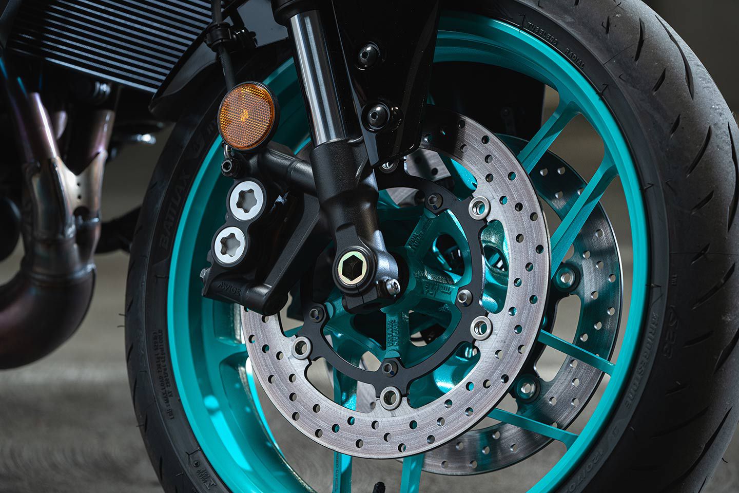 The MT-09 is shod in Bridgestone Battlax Hypersport S23 tires and the SpinForged Aluminum wheels really pop in the cyan coloring.