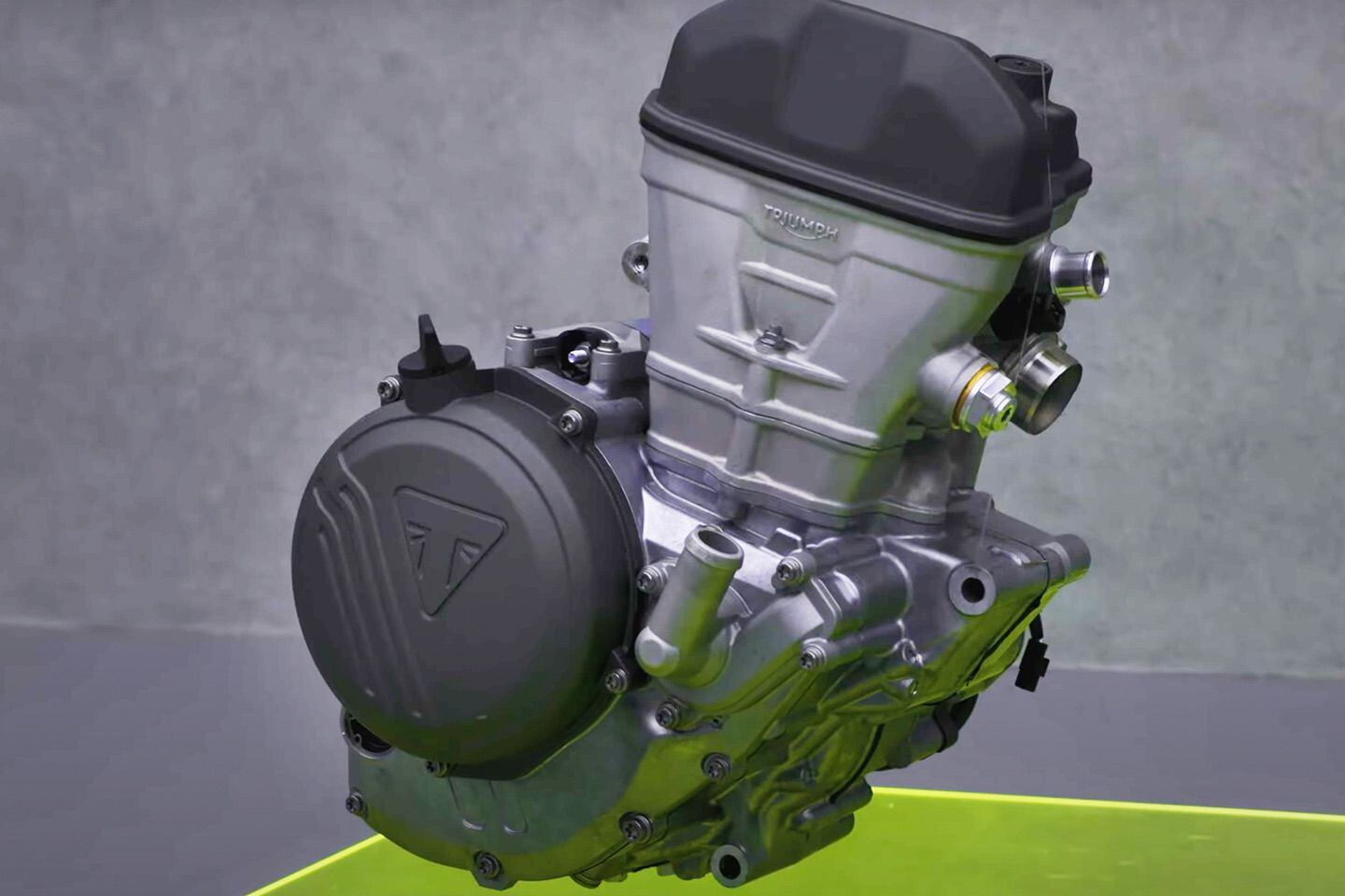 The cam-chain tensioner on the front of the engine caused many to believe the engine spins opposite to the wheels, but that is not the case.