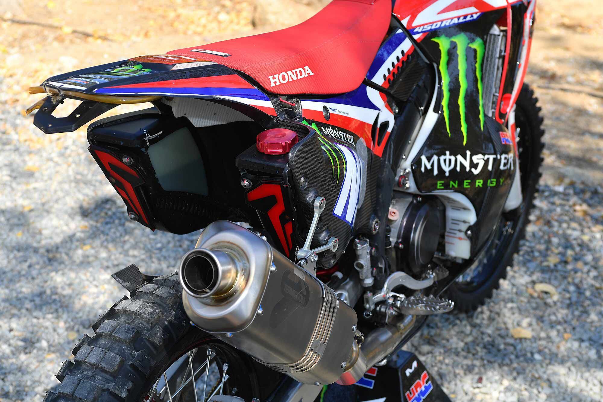 Instead of aluminum tubing, the CRF450 Rally subframe is carbon fiber, sourced from Toray Carbon Magic. It carries the two rear fuel tanks which are connected by a crossover tube. Underneath the Noguchi seat (speedily removable via a quick-disconnect pin on each side) is a carbon fiber tray holding many of the electrical components; it can be quickly removed for service.