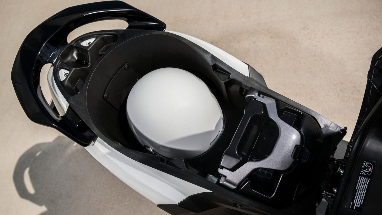 The Neo’s underseat 27-liter storage area has room for one jet-style helmet—unless you stick another battery in there.