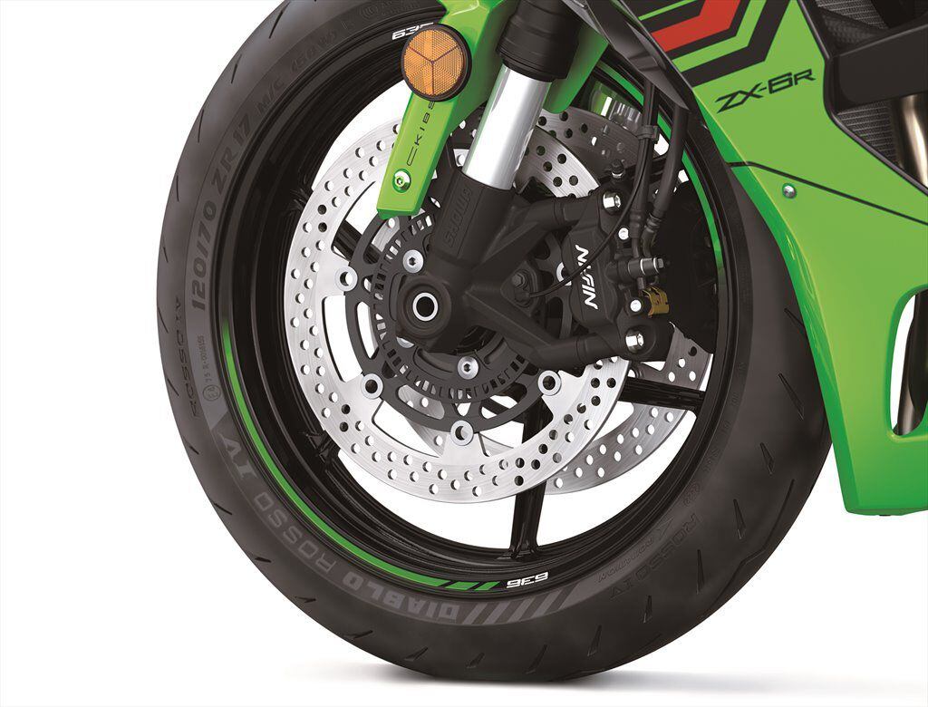 The front brake calipers are the same four-piston, radial-mount Nissins, but the petal discs of old are gone.