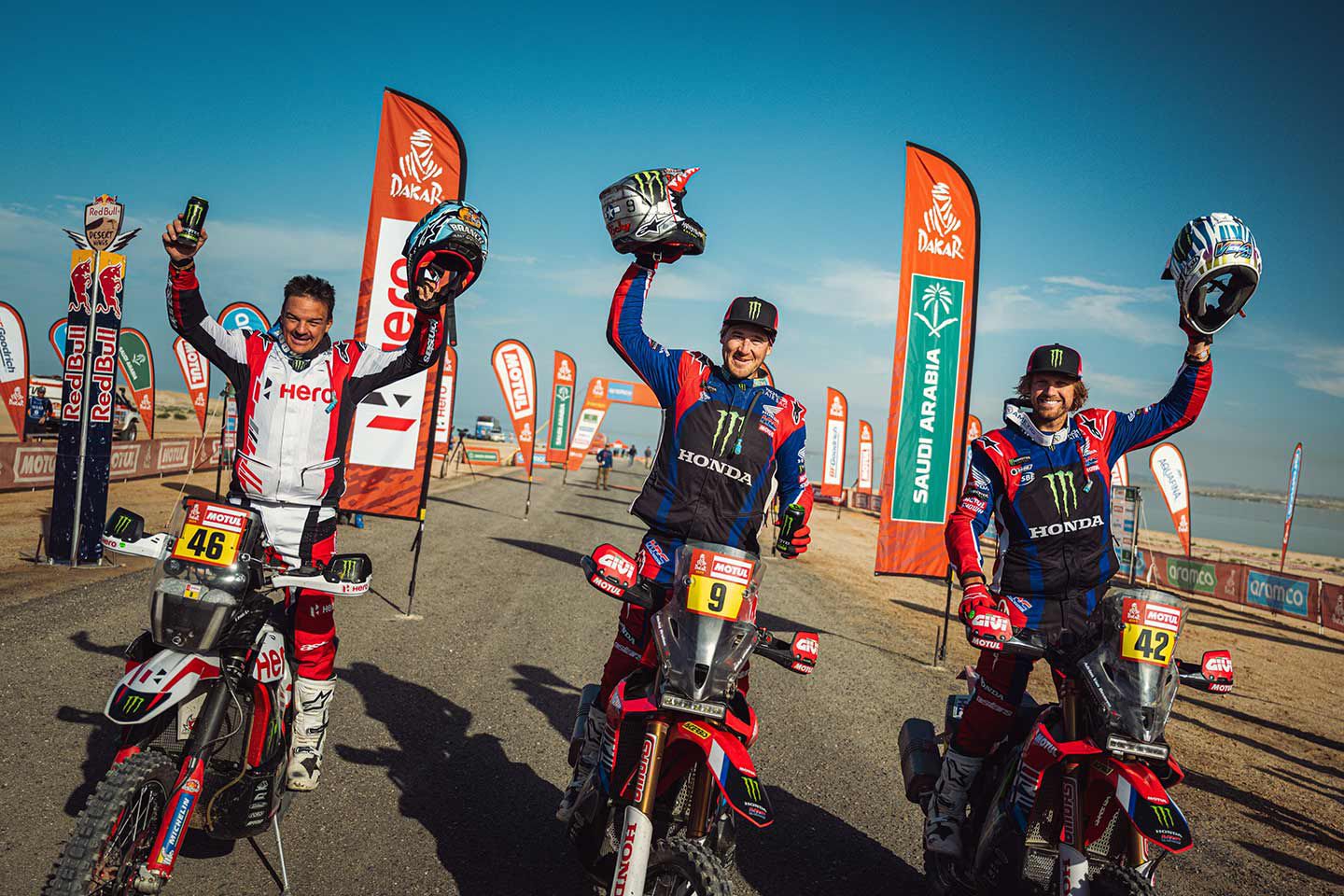 Friends at the end: Ricky Brabec, Ross Branch, and Adrien Van Beveren celebrate the podium of the 2024 Dakar Rally.