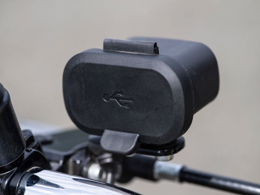 A left handlebar-mounted USB charger is out of place on the Gold Star.