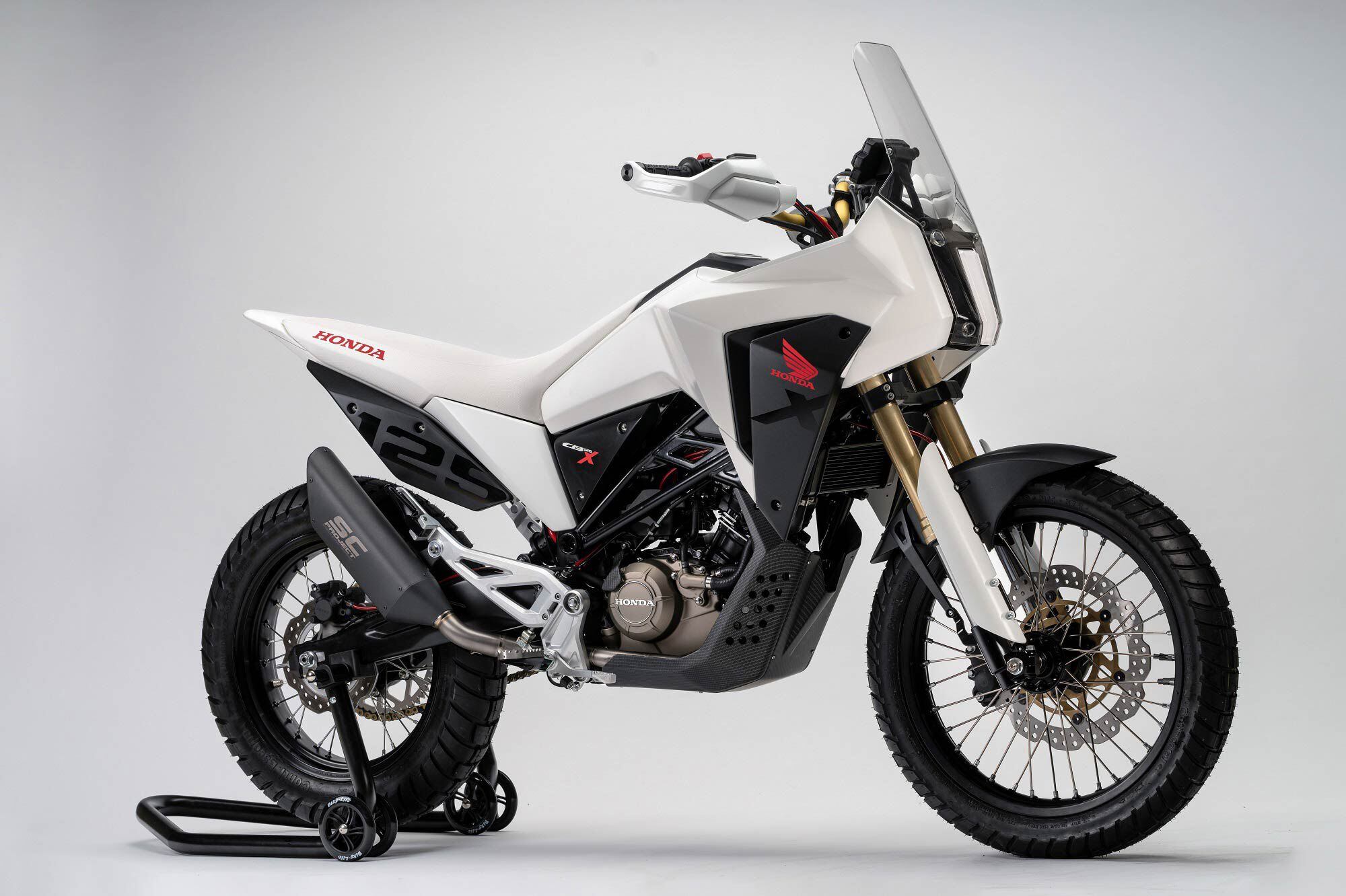 The stacked headlights and side cowls suggest influences from Honda’s Africa Twin as well as the CB125X concept shown at EICMA in 2018.