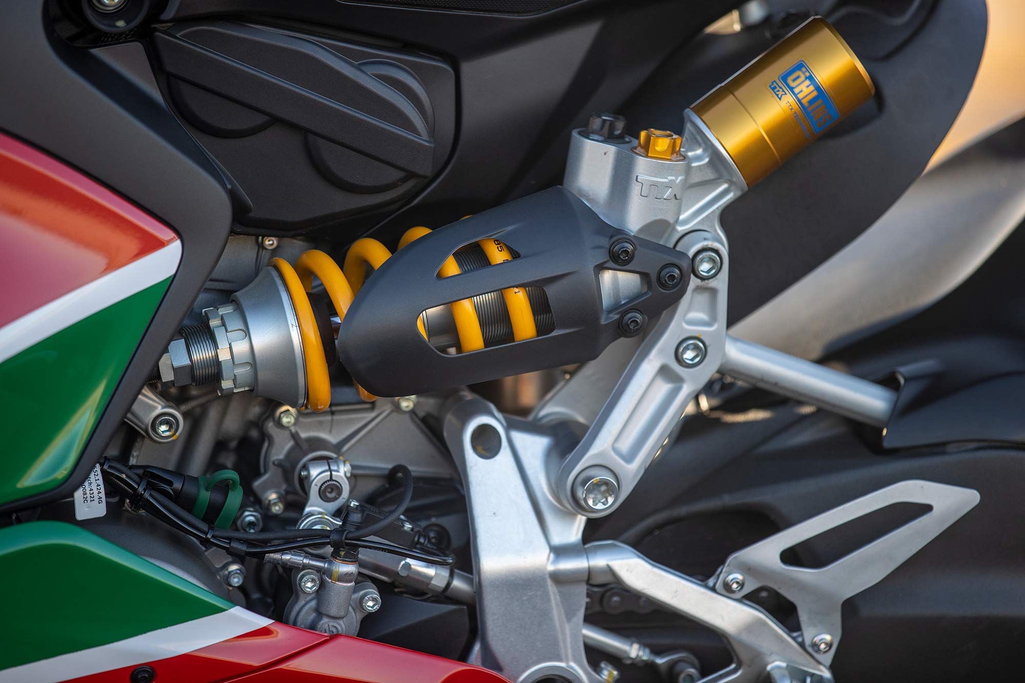 The Öhlins TTX 36 shock is actuated by a rocker link to the single-sided swingarm.