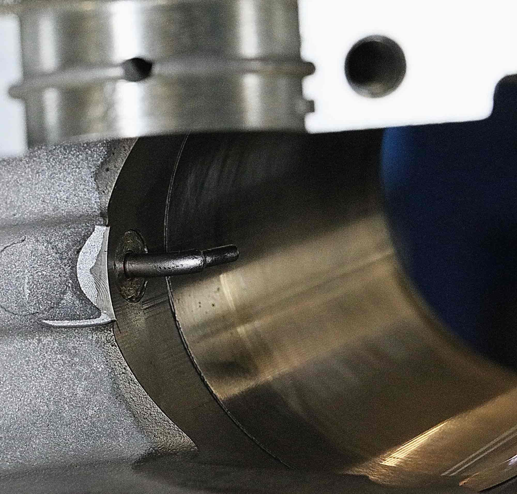 A nozzle spraying a jet of cooling oil to the underside of each piston is located at the bottom of each cylinder bore.