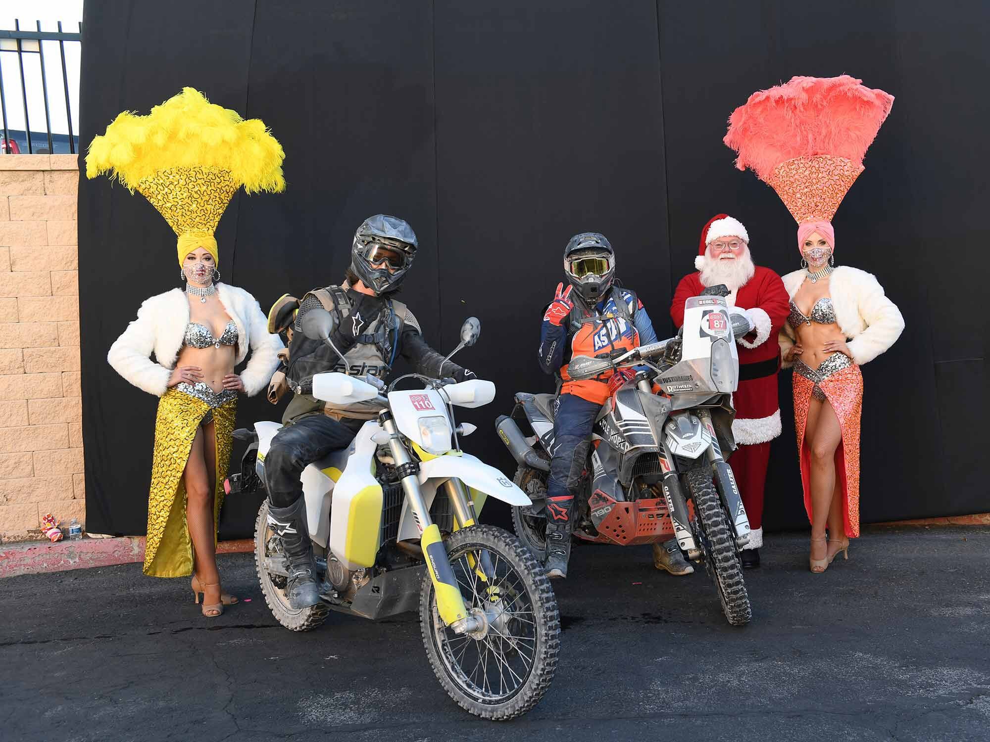 Santa Claus and showgirls wait for photos at the LAB2V finish line.