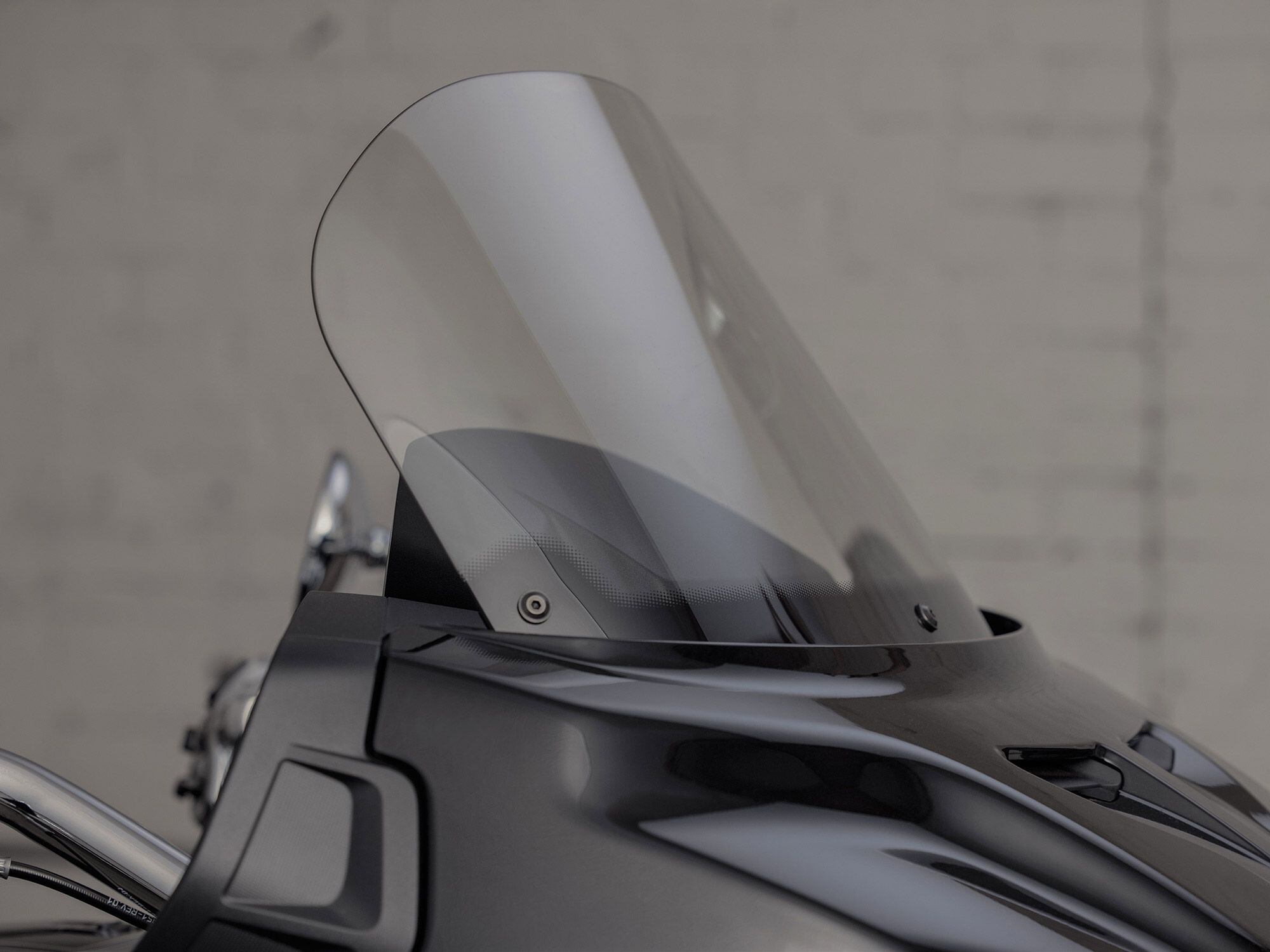 Up front, the fixed fairing and adjustable shield combo offer wind protection for longer trips.