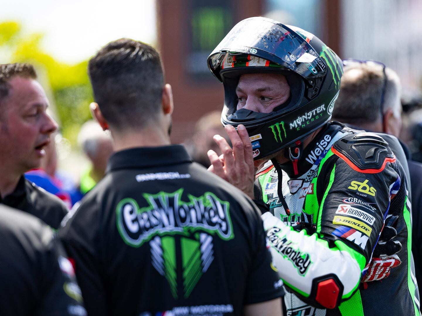 Peter Hickman, back in the pit after his initial lap, talks to his crew concerning adjustments to the BMW M 1000 RR before his next practice lap.