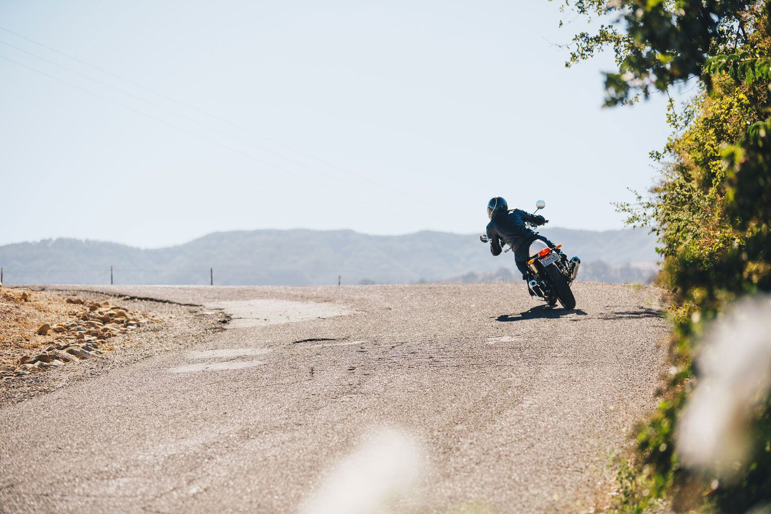 Roll off the gas and onto the brakes; coasting means less control—especially on unknown roads and blind corners.