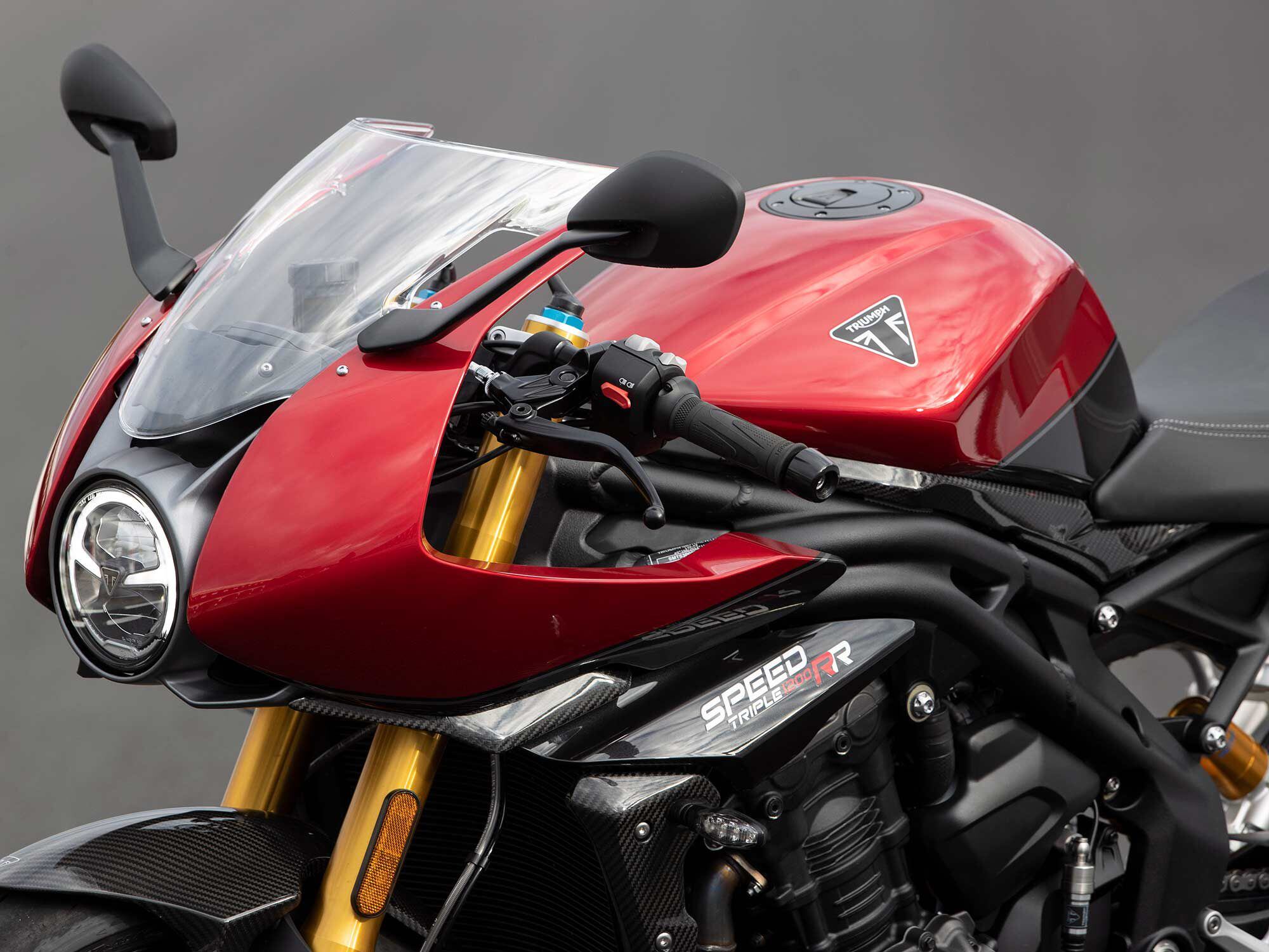 Clip-on handlebars tucked behind a bikini fairing add sporting character to the Speed Triple 1200 RR over the RS.