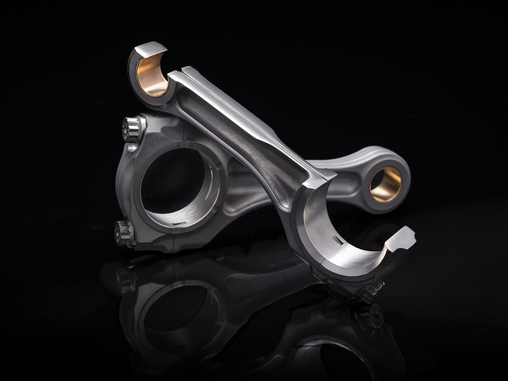 Drilled titanium connecting rods for improved flow of cooling oil.