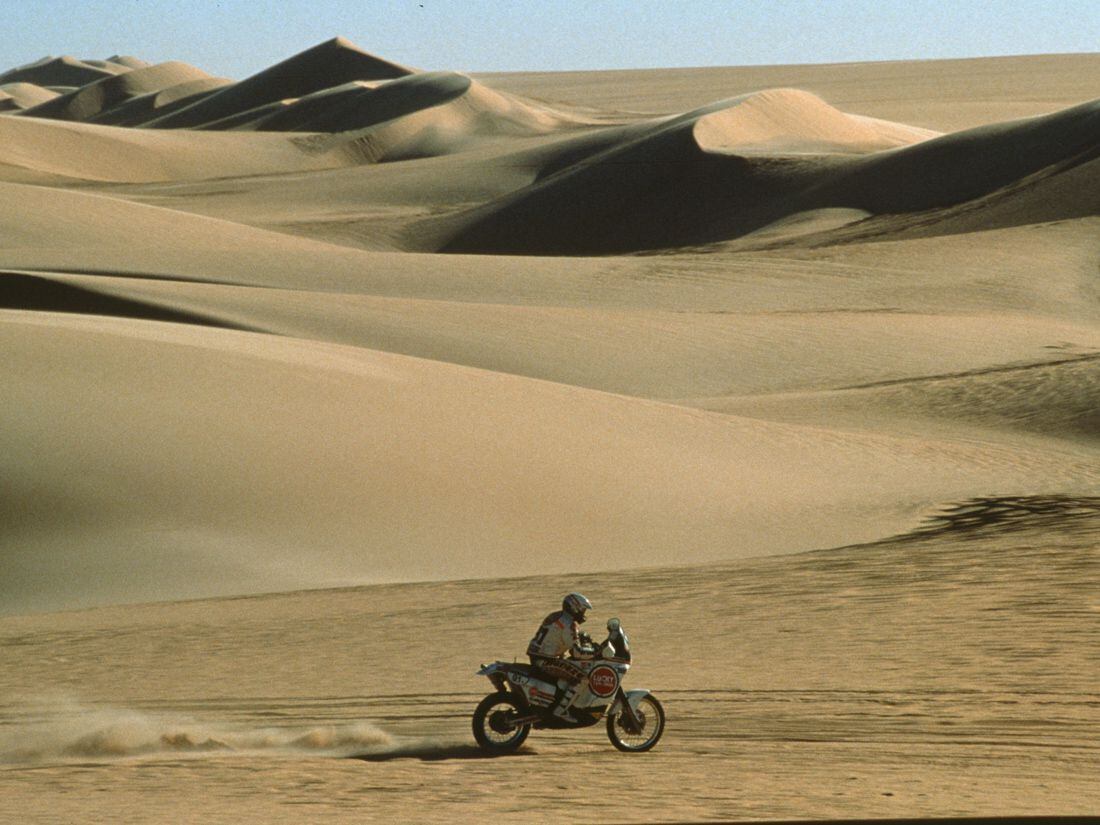 Dunes like this? Giant fuel tank? Must be Dakar! The venue and the machines have changed over the decades, but the spirit of the rally has never wavered. Here we see Ciro de Petri riding to a podium finish on a Cagiva Elefant 900 in 1990. A fellow Cagiva team member won that year.