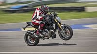 2023 ducati monster 1200 s popping wheelie on racetrack