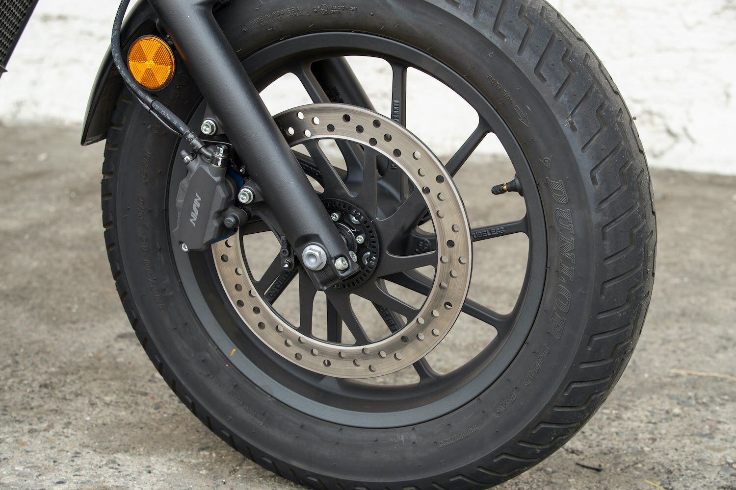A Nissin caliper squeezes on a 296mm disc for front-end stopping power.