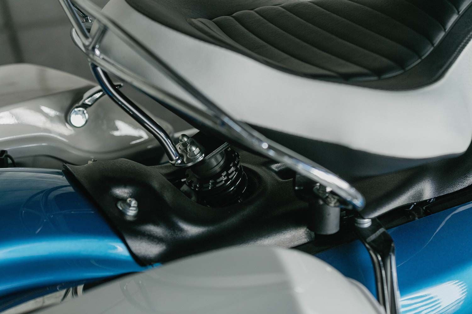 The chrome seat railing mounts to a shock absorber underneath.