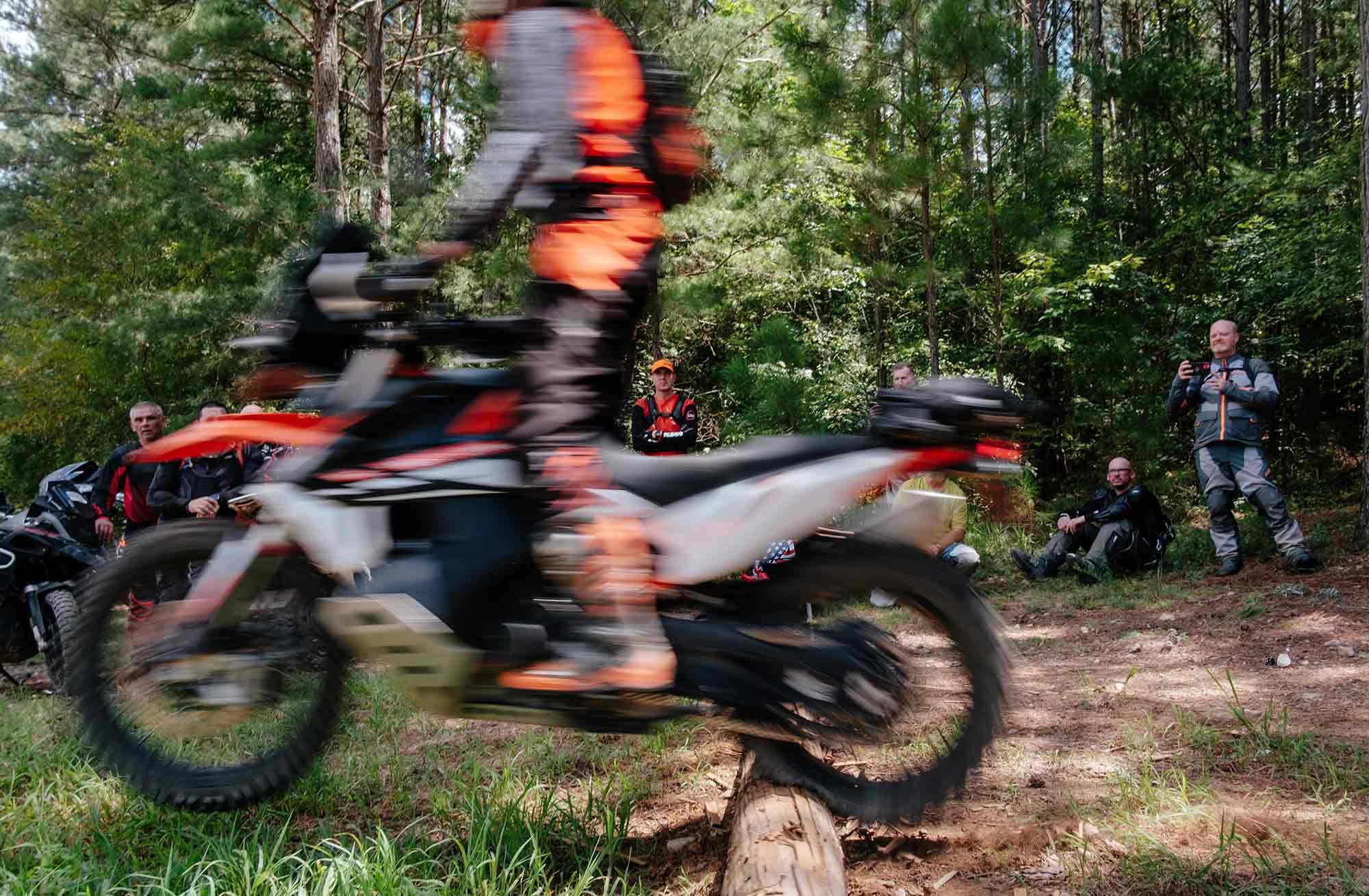 The class looks on as Birch shows the impact of the rear tire on a log at speed without proper technique.