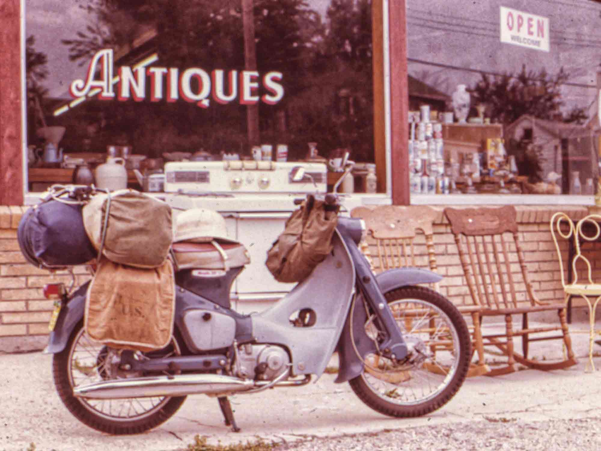 Antiques, indeed: US Army mule packs for panniers. Also cool wire wheels and a versatile dual bench seat.