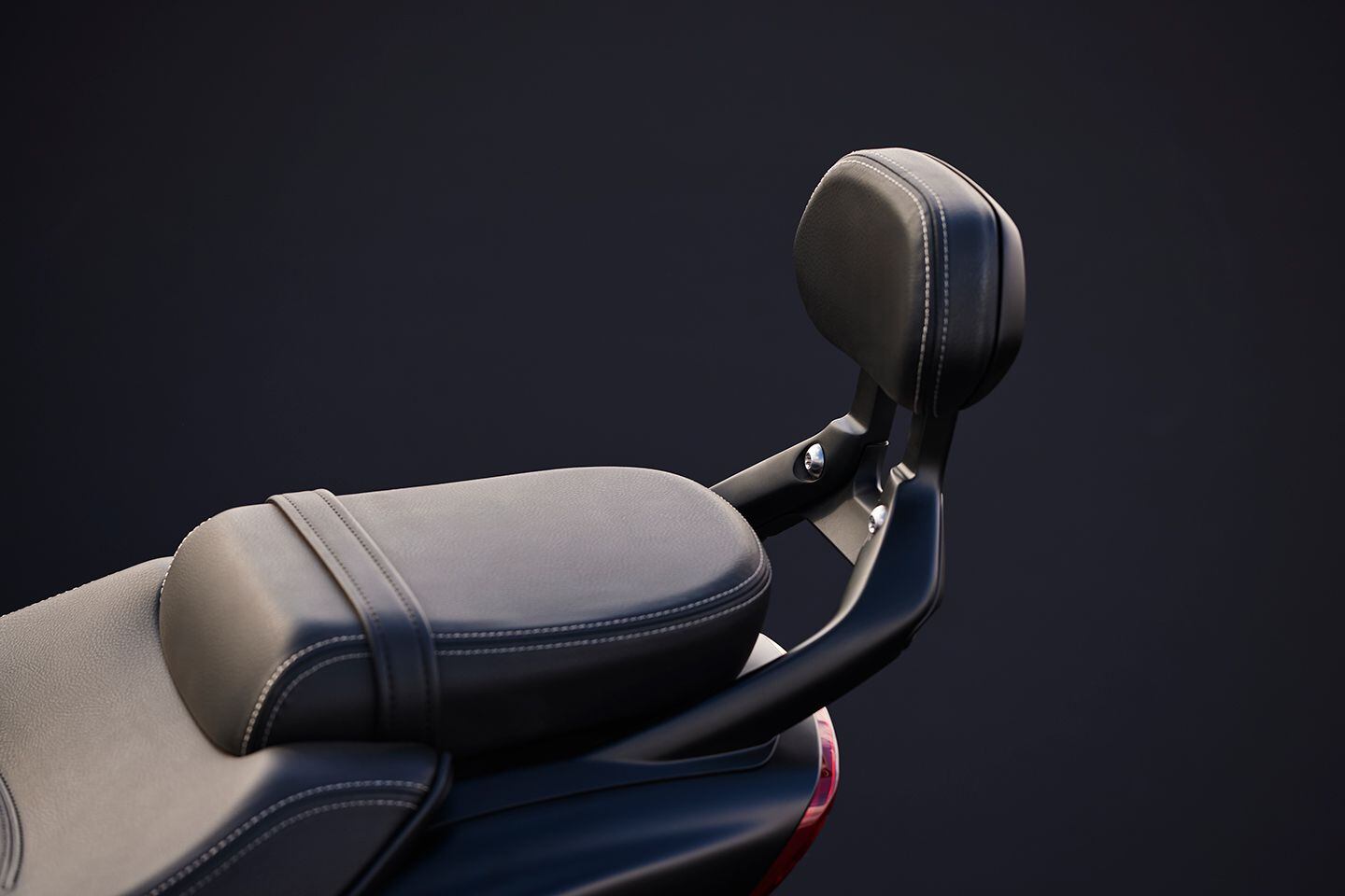 GT models feature a passenger backrest that’s quickly adjustable with a tab under the backpad.