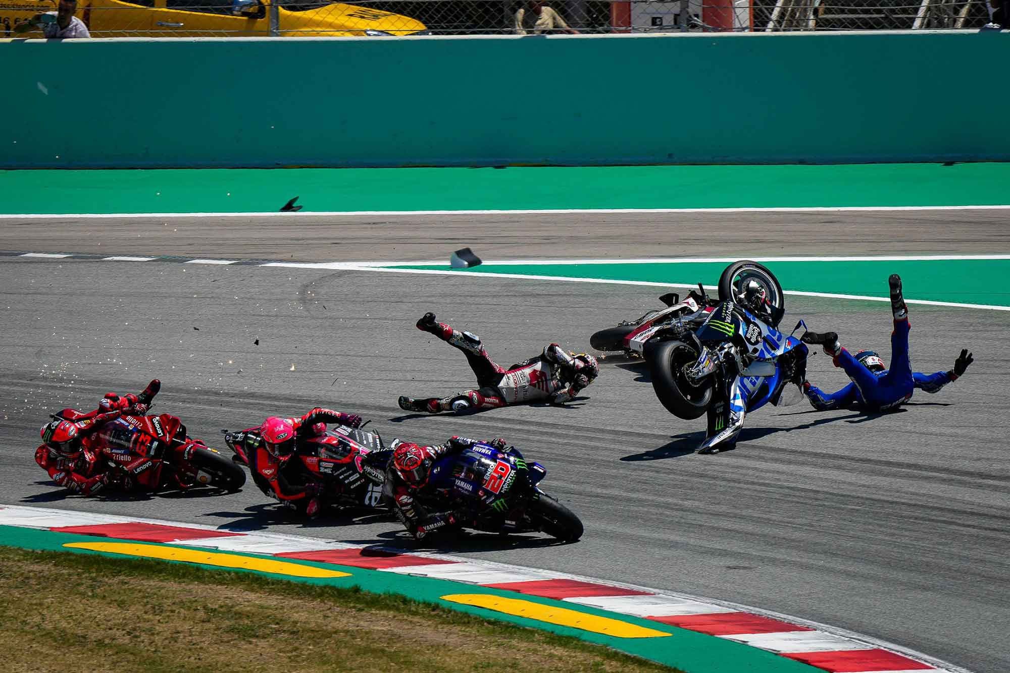 The first of multiple crashes during the Catalunya MotoGP round: Takaaki Nakagami bowled down Álex Rins and Francesco Bagnaia as he lost the front going into turn 1 at the start of the race. Several riders crashed out with front-end washouts.