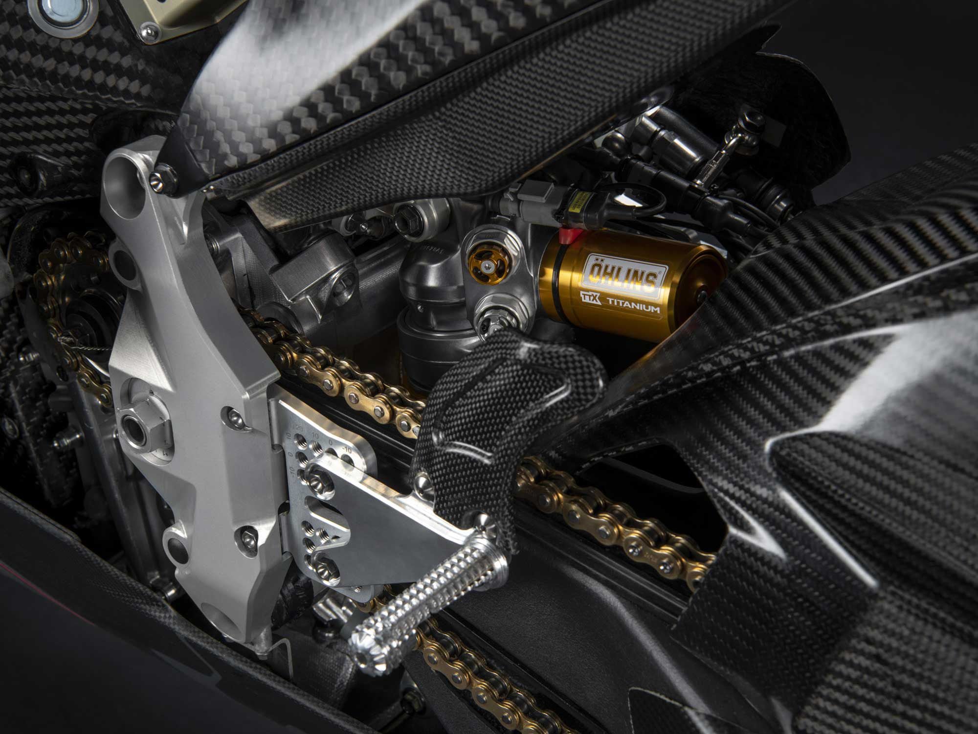 Öhlins suspension front and rear. Also note how aluminum chassis structures like the swingarm pivot (shown here) and the steering head join the carbon fiber battery-box monocoque.