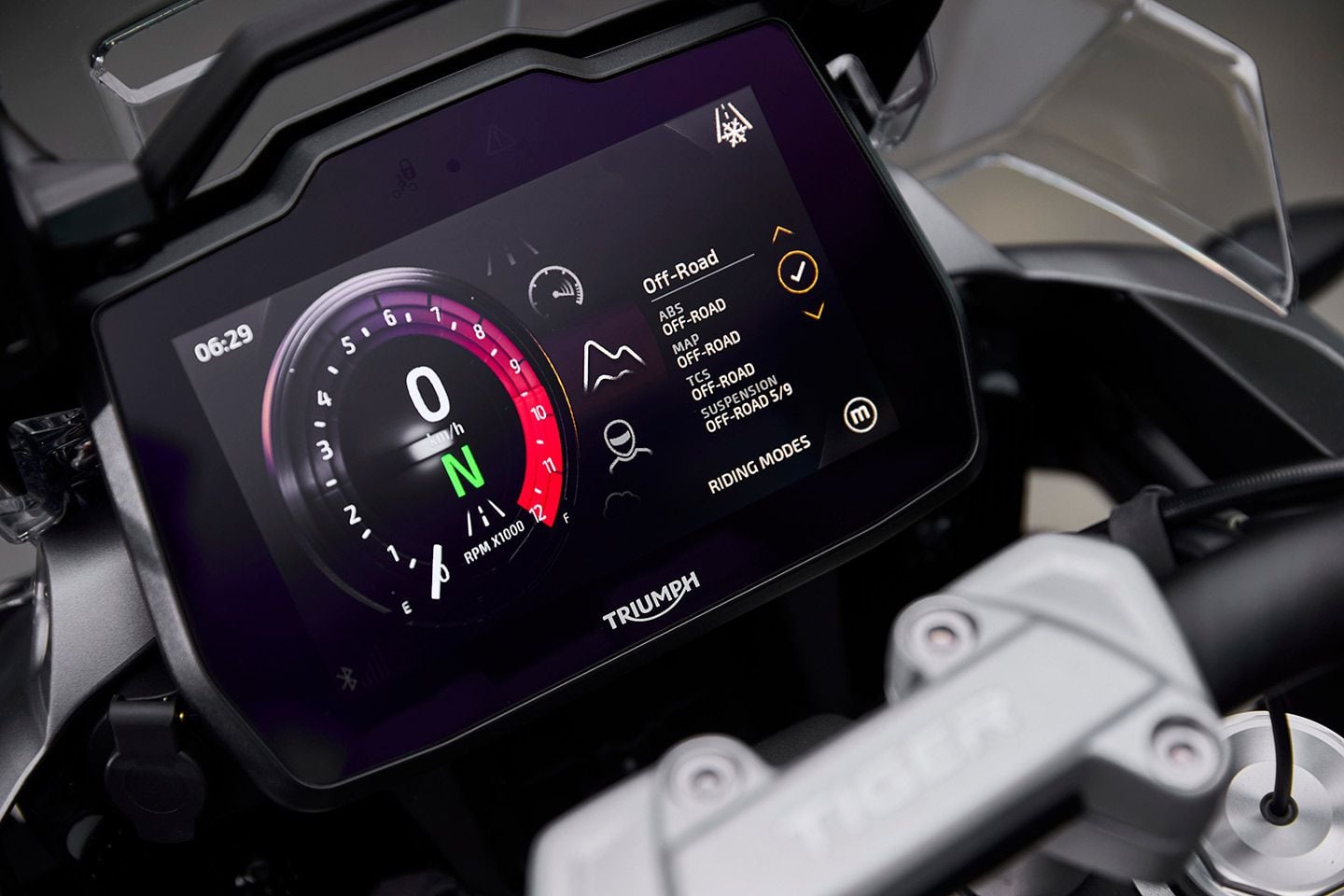 The Tiger 1200 uses a six-axis IMU to manage cornering ABS and traction control. The GT models have five ride modes (Rain, Road, Sport, Rider, and Off-Road); the Rally models add Off-Road Pro which turns off ABS on both the front and rear. Adjusting rider-aid settings on the 7-inch TFT display is relatively intuitive, but arguably less so than on the previous generation (2018–2021).