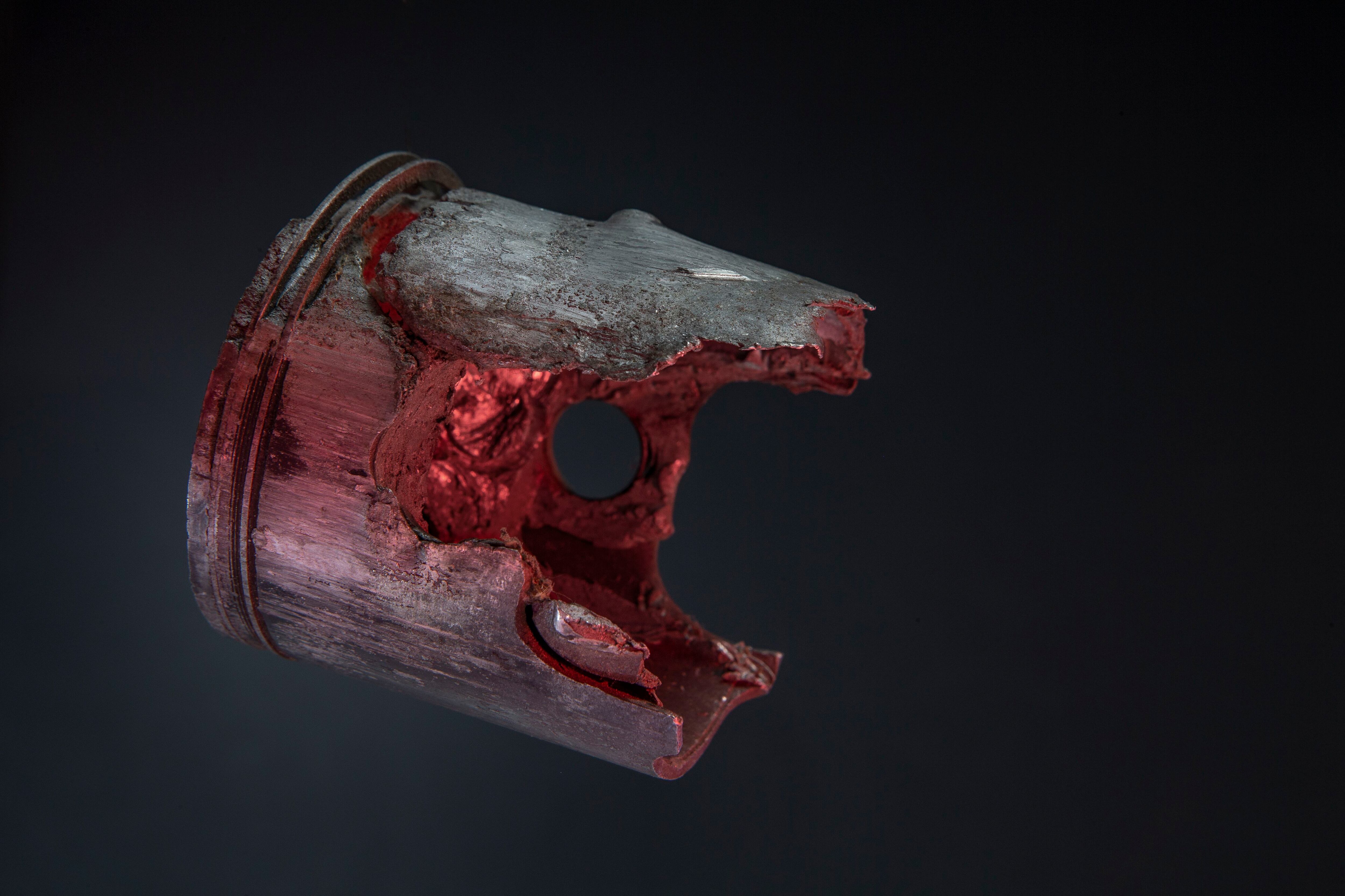 Detention typically occurs near bottom dead center and around the edges of the cyclinder. This Kawasaki H2R 750cc triple piston died of detonation, destroying the top land and then moved onto ring lands. Eventually it seized.
