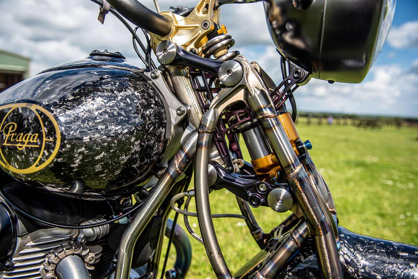 A girder fork is fitted with an Öhlins shock. Rear “suspension” is also an Öhlins unit attached to the single seat.
