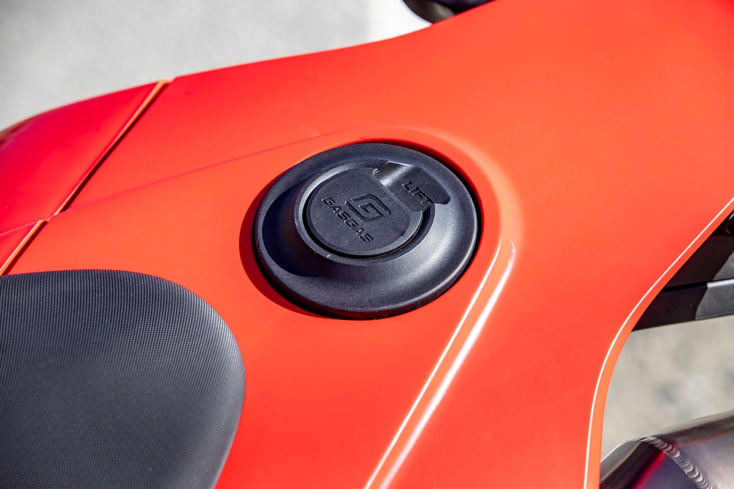 The additional weight of the gas tank at the rear of the motorcycle loads the chassis in unfamiliar ways during wheelies, stoppies, or under hard acceleration.