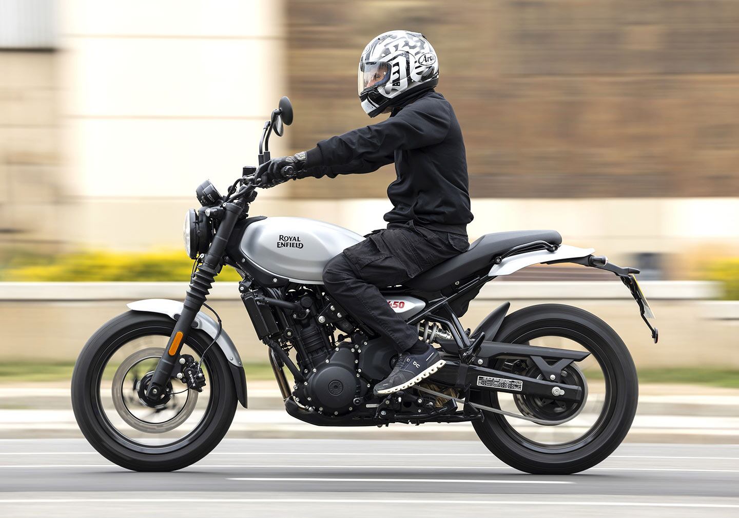 The stepped bench saddle, new subframe, and mid-mount pegs enable an upright riding position. The Guerrilla wears 17-inch tubeless hoops on both ends. Shown is the Analogue variant in Smoke Silver, which should be available in North America.