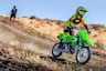 Youth rider on mini dirt bike riding downhill