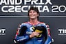 Joe Roberts holds hat on chest in Moto2 paddock