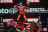 Marc Marquez leaps off race bike with trophy at Assen MotoGP race