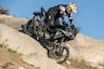 2025 CFMoto Ibex 450 riding downhill over large boulder