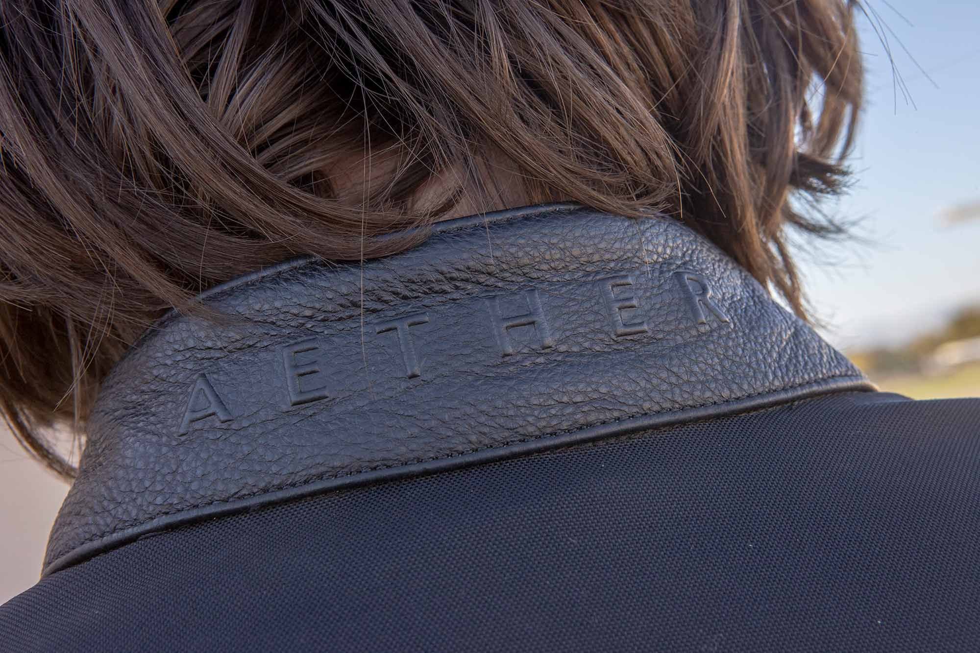Branding detail on the collar of the Aether Draft jacket.