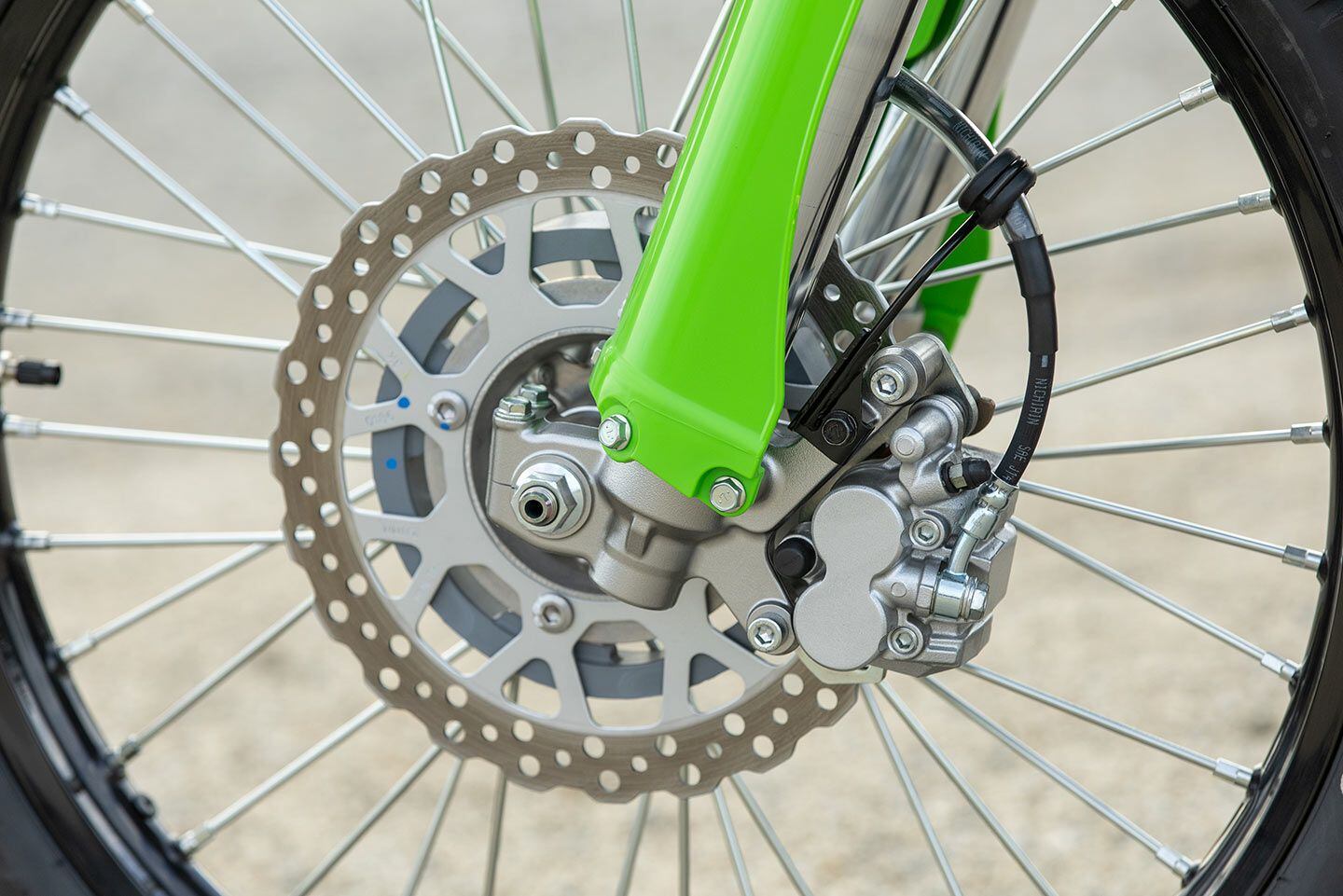 The 2024 Kawasaki KLX300’s braking system utilizes a 250mm disc and dual-piston caliper.