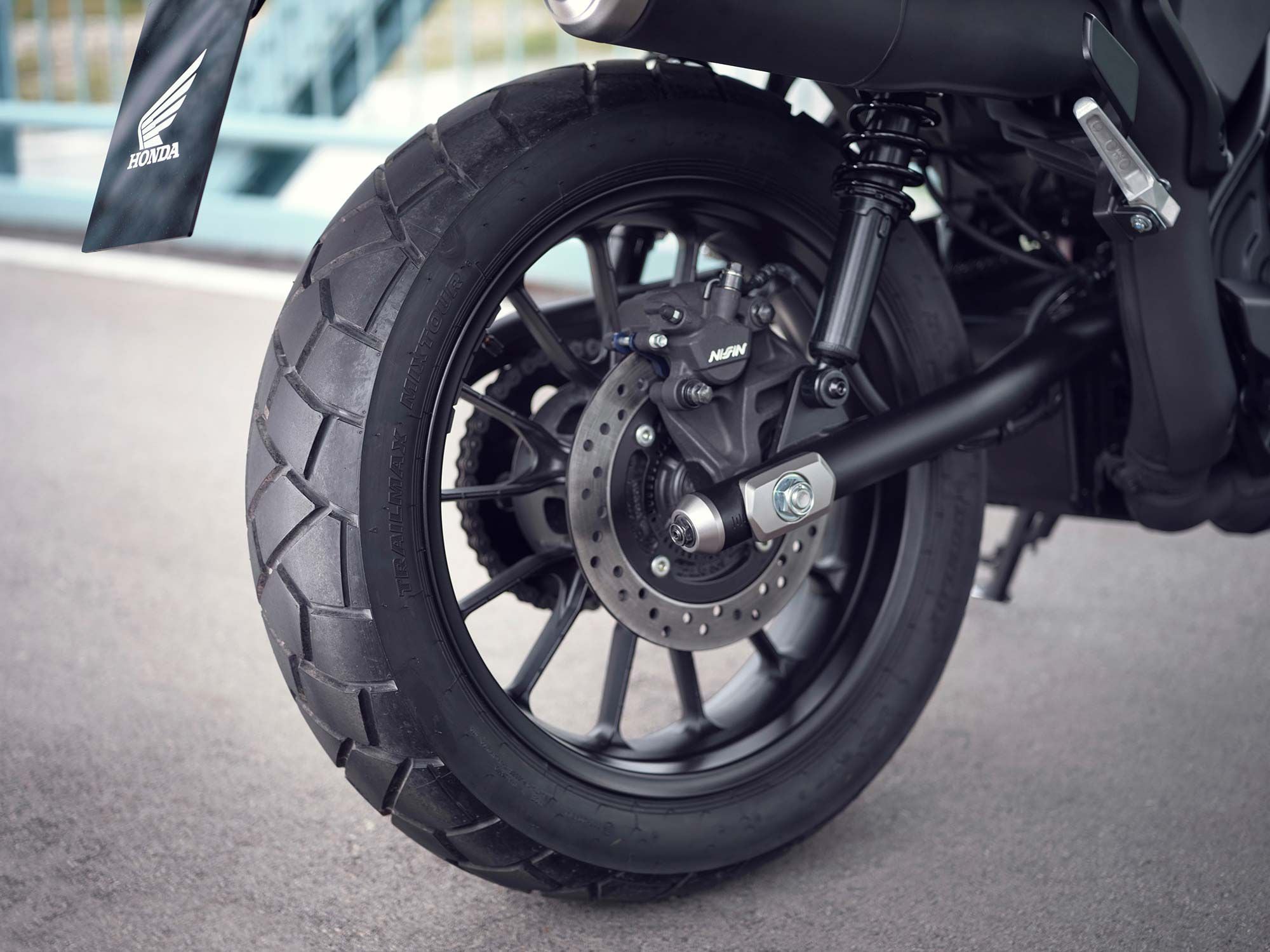 A simple tubular steel swing arm is controlled by a pair of preload-adjustable shocks.