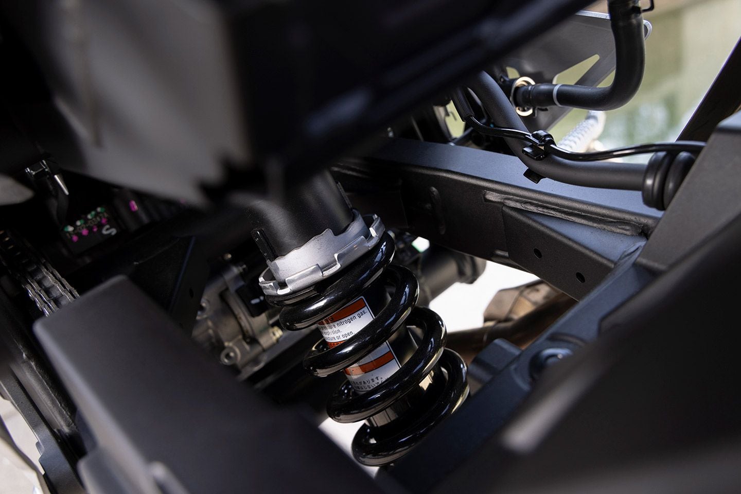 The fork and shock use stiffer spring rates and more aggressive valving to accommodate for the added weight. The only adjustment is spring preload at the rear.