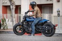2023 Harley Davidson Sportster S parked on city street with rider aboard