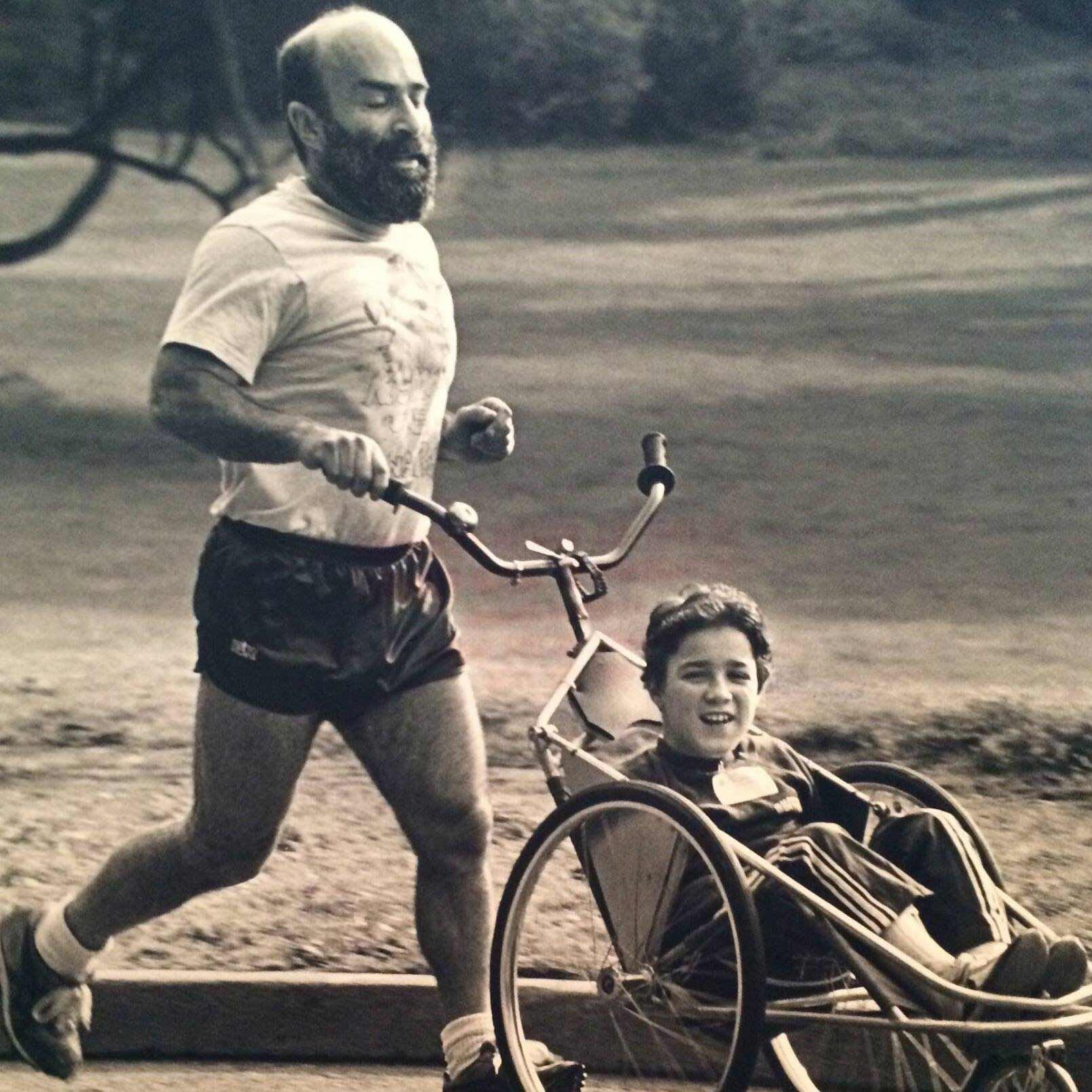 Here are Sandy Kosman and dearly beloved son Seth, out for a look at the world. Seth, born with muscular dystrophy, rides in a handlebar buggy designed by dad.