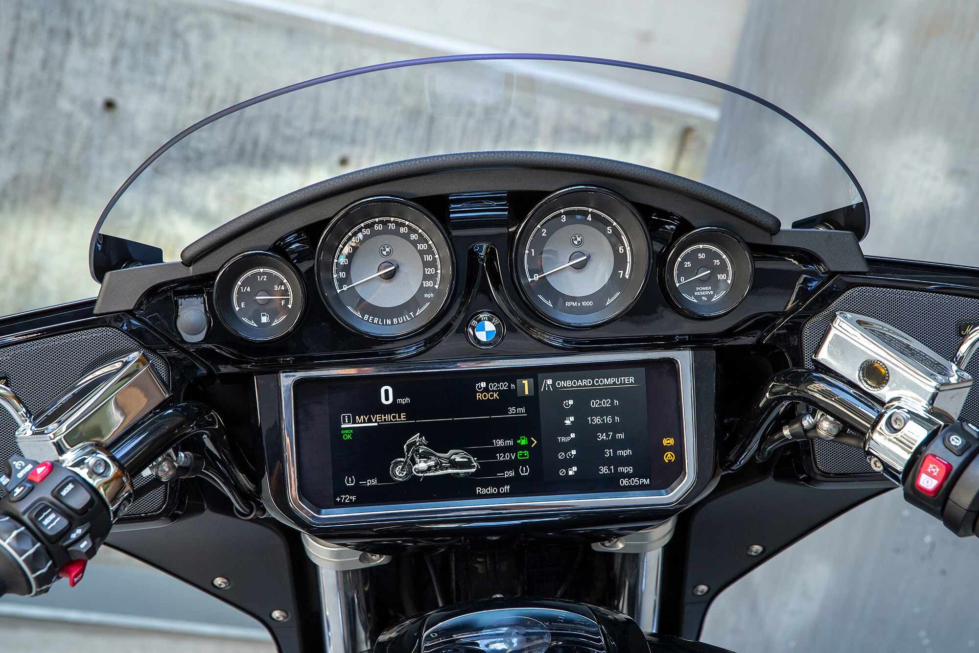 The R 18 touring platform features a 10.25-inch display screen, four analog gauges, and fairing-mounted speakers.