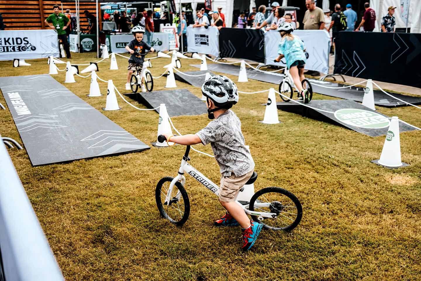 Little ones grow up to be big ones. BMW makes sure kids get in on the fun with e-bikes and cones.